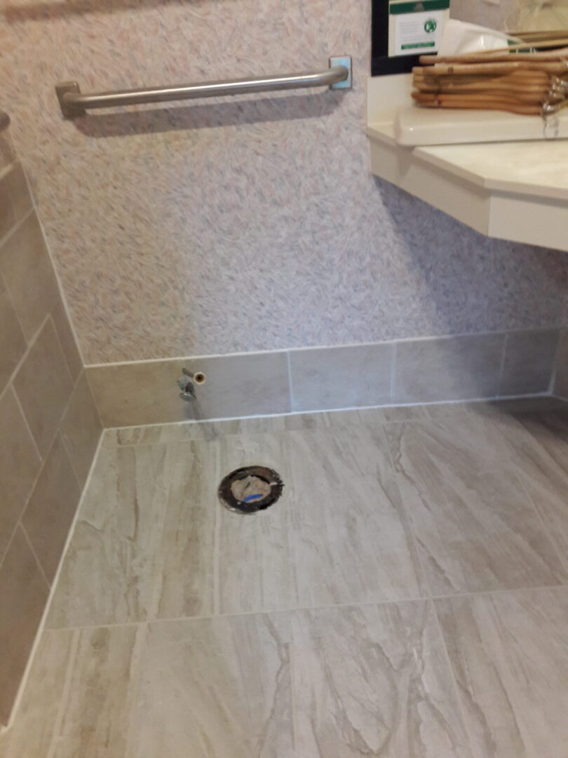 A bathroom with a sink and tiled floor