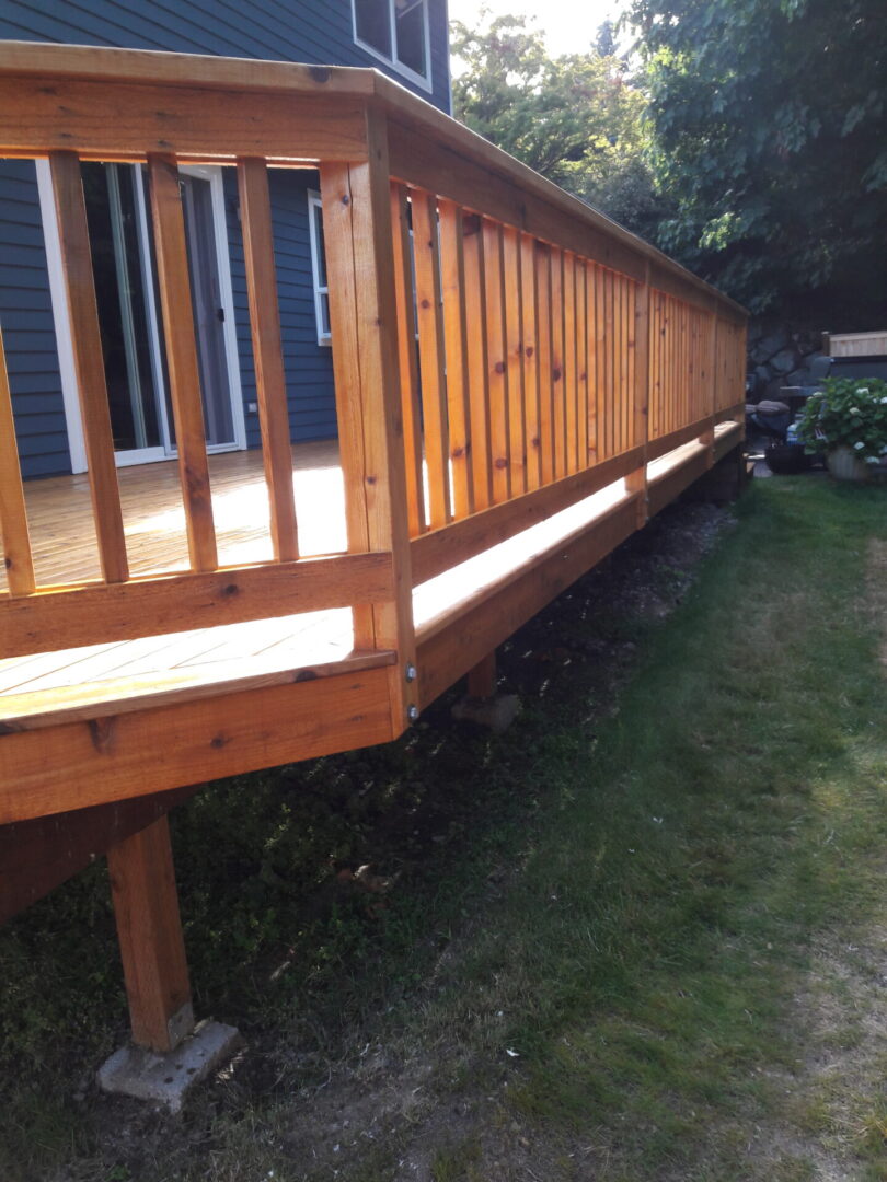 A wooden deck with a railing and steps.