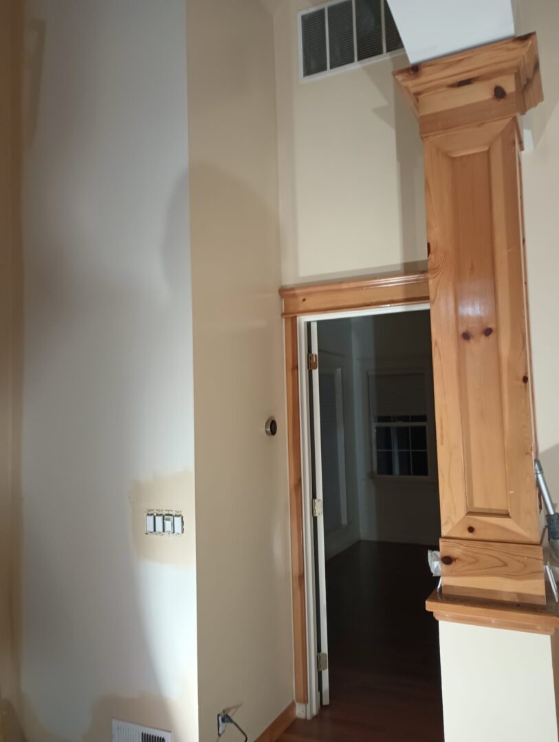 A tall wooden cabinet in the corner of a room.