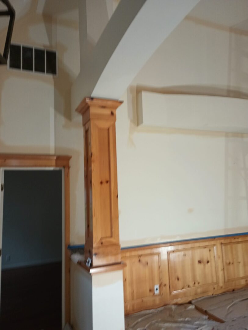 A room with wooden cabinets and white walls.