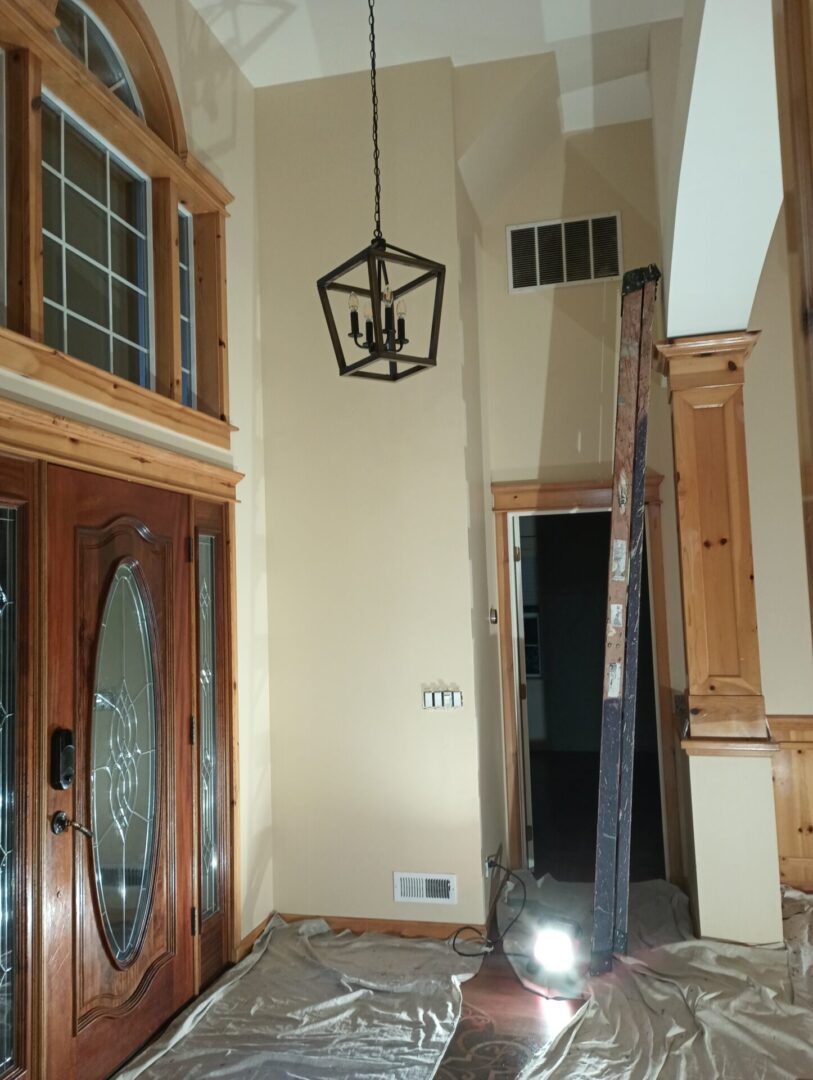 A view of the inside of a house with a light hanging from the ceiling.