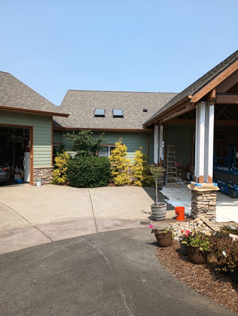 A large driveway with a house and garage in the background.