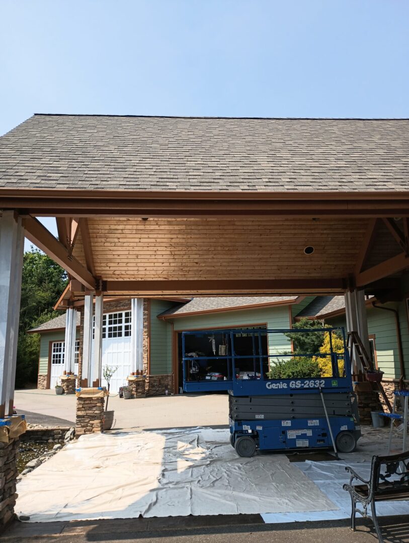 A large open garage with a wooden roof.