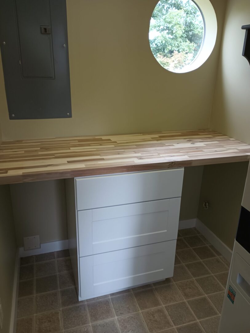 A desk with drawers and a wooden top.