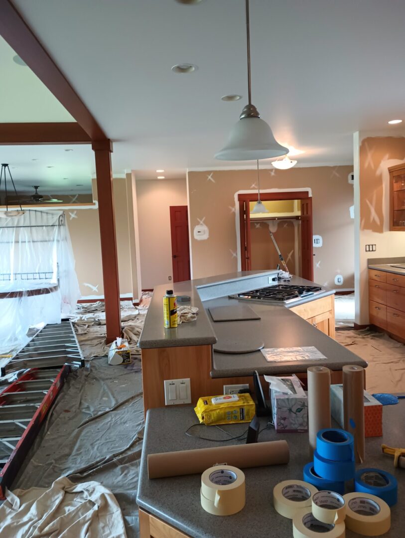 A kitchen with many items on the floor